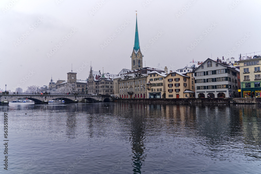 Beautiful cityscape of the old town of Zürich with protestant church Women's Minster, Minster Bridge and Limmat River in the foreground. Photo taken December 16th, 2022, Zurich, Switzerland.