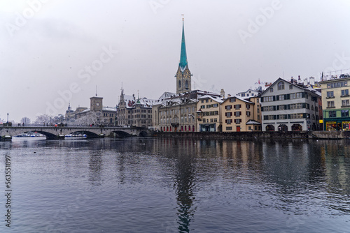 Beautiful cityscape of the old town of Zürich with protestant church Women's Minster, Minster Bridge and Limmat River in the foreground. Photo taken December 16th, 2022, Zurich, Switzerland.