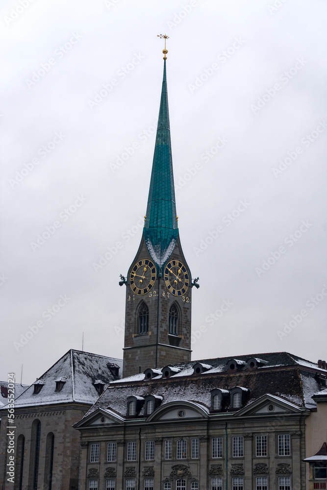 Snow covered church tower of protestant church Women's Minster at the medieval old town of Zürich on a snowy gray clouded alte autumn day. Photo taken December 16th, 2022, Zurich, Switzerland. Snow covered church tower of protestant church Women's Minster at the medieval old town of Zürich on a snowy gray clouded alte autumn day. Photo taken December 16th, 2022, Zurich, Switzerland.