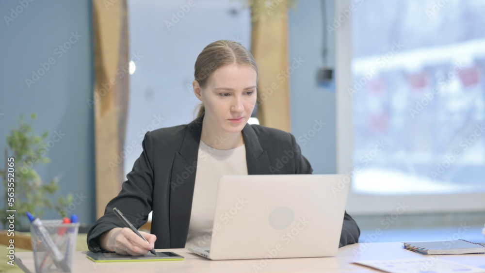 Female Graphic Designer Working on Laptop and Graphic Tablet Female Graphic Designer Working on Laptop and Graphic Tablet