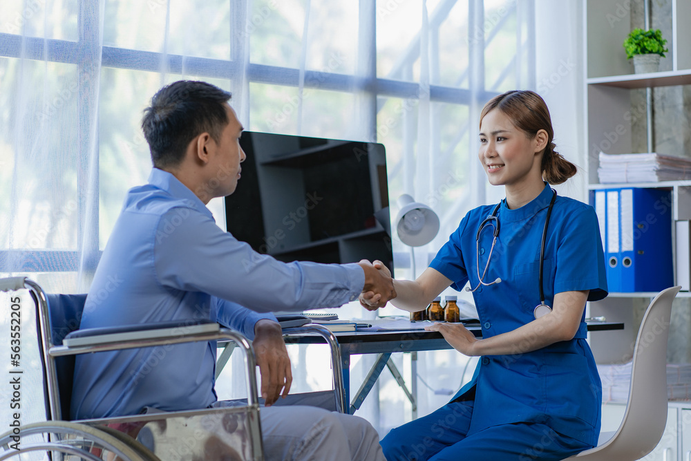 Asian male patient shaking hands with female doctor in office They were sitting at the table. Discuss hospitalization, health care concept, handshake, greetings and thanks. Asian male patient shaking hands with female doctor in office They were sitting at the table. Discuss hospitalization, health care concept, handshake, greetings and thanks.