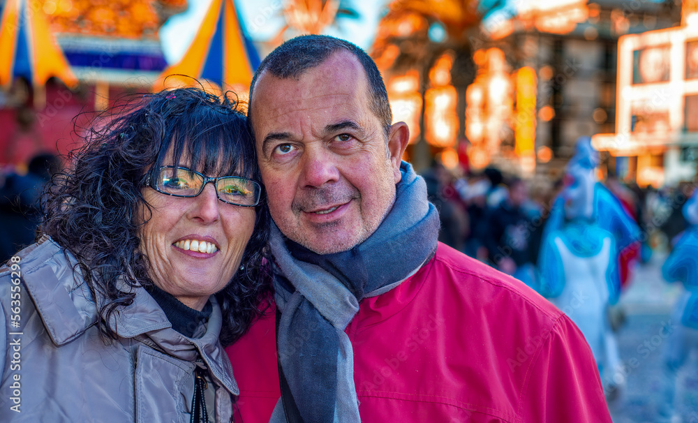 Happy caucasian couple attending Carnival Parade in Viareggio