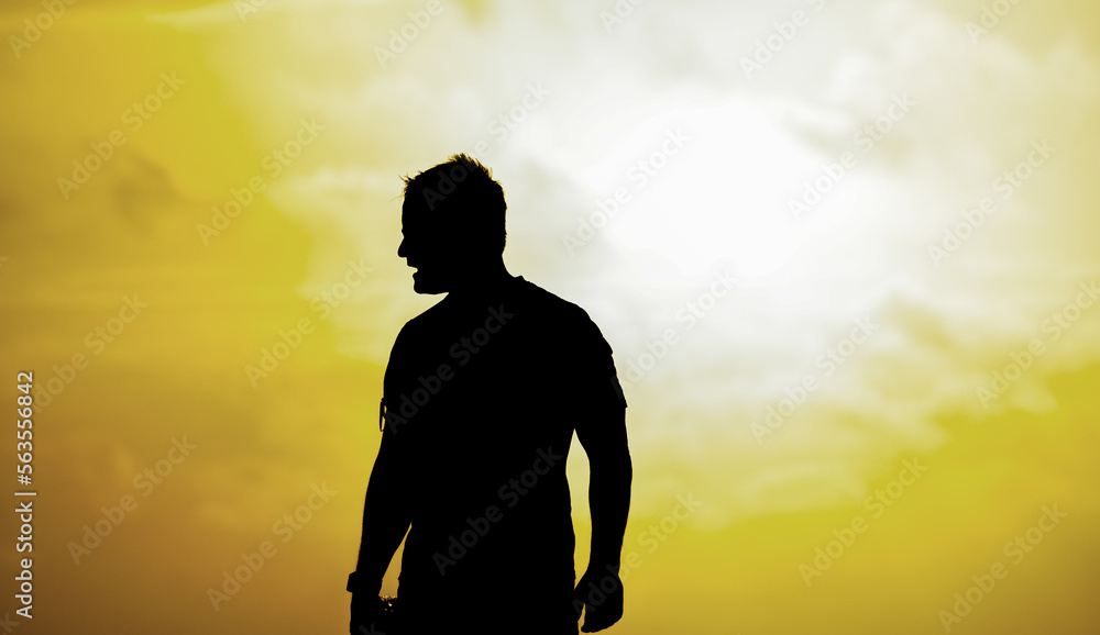 Silhouette of a man looking to the sea on the beach