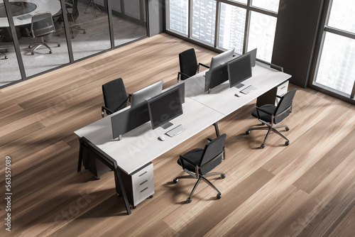 Top view of grey workspace interior with pc computer and armchairs