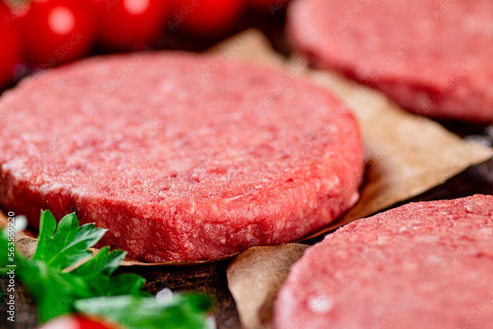 Raw burger with fresh tomatoes. Raw burger with fresh tomatoes.