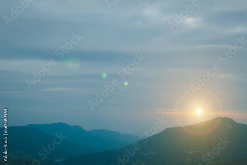 Natural fog and mountains sunlight background blurring, misty waves warm colors and bright sun light. Sky sunny color orange light patterns evening on clouds blur.