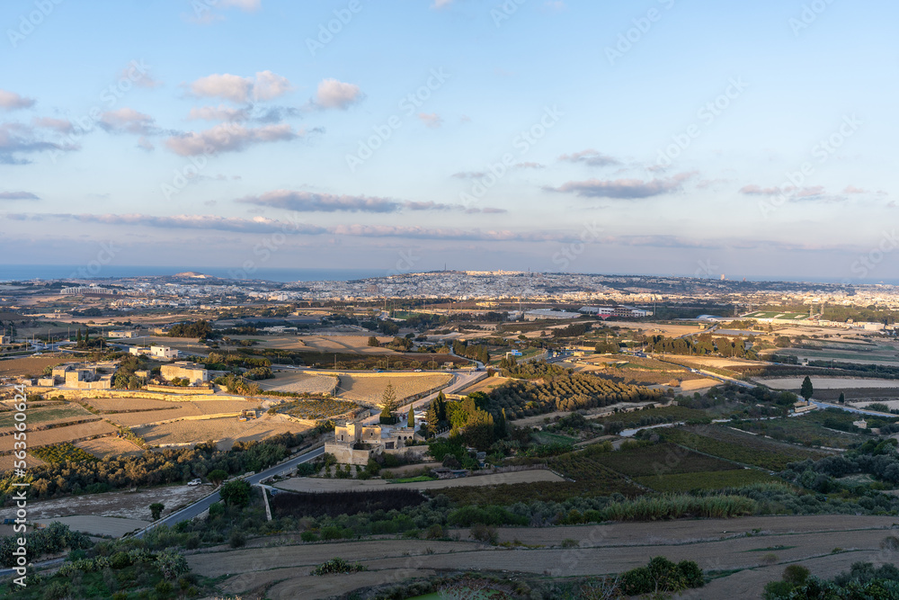 Obraz premium Sunny view at golden hour of surrounding fields from tower of Mdina