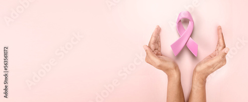 hands holding 3d pink ribbon for symbolic of encurage breast cancer awareness 