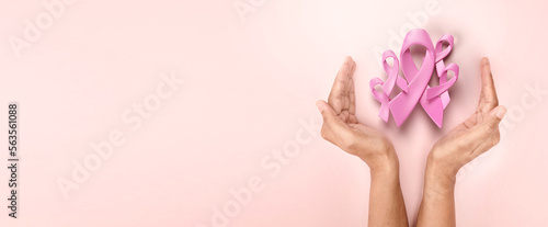 hands holding 3d pink ribbon for symbolic of encurage breast cancer awareness 