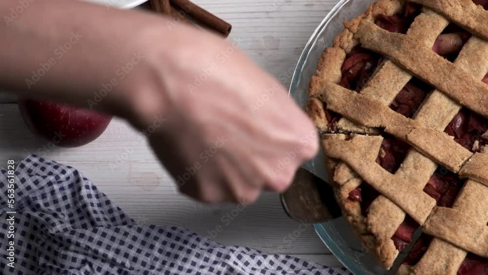 Woman's hand taking apple pie. Homemade apple pie with apples and cinnamon. Traditional american dessert. Woman's hand taking apple pie. Homemade apple pie with apples and cinnamon. Traditional american dessert.