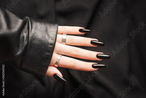 Hands of a young girl with black  manicure on nails