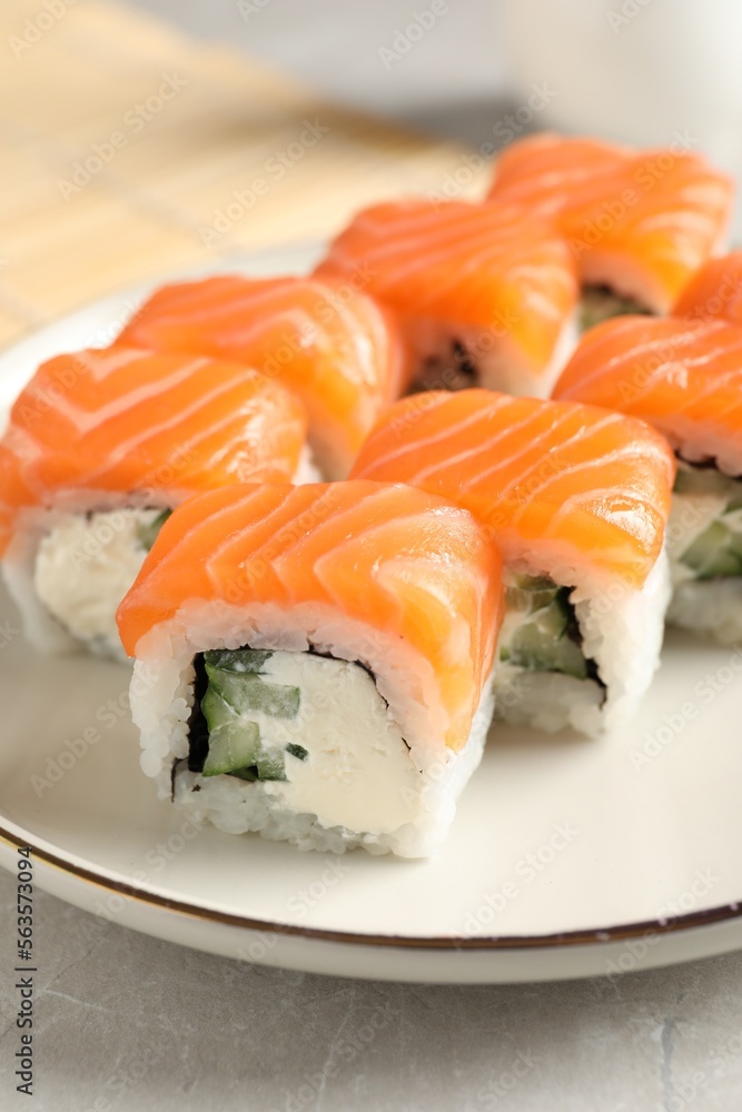 Tasty sushi rolls served on grey table, closeup Tasty sushi rolls served on grey table, closeup