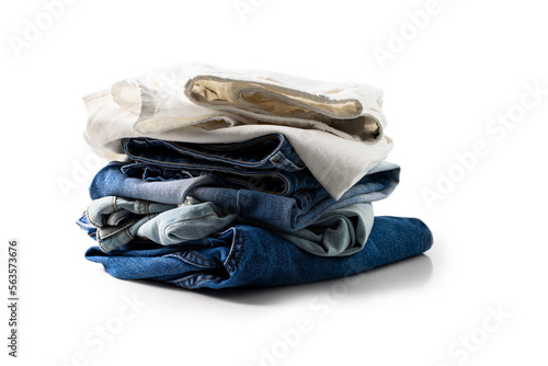 Stack of different colors jeans on white background for Shop, sale concept. photo