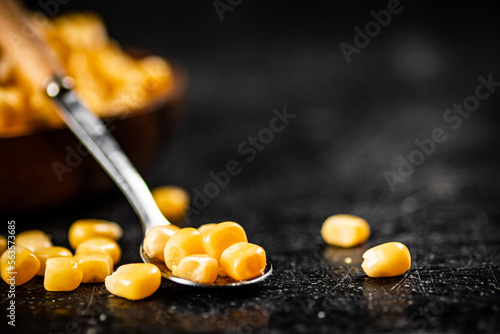 Grains of canned corn in a spoon. 