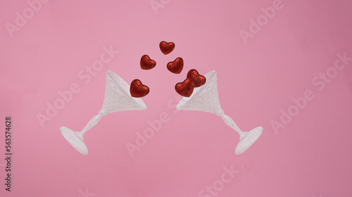 Red glitter heart floating away from white glass. Minimal love concept. Valentine's Day love concept on pink background.