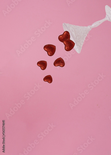 Shiny glass dropped  Red glitter heart. Minimal love concept. Valentine's Day love concept on pink background.