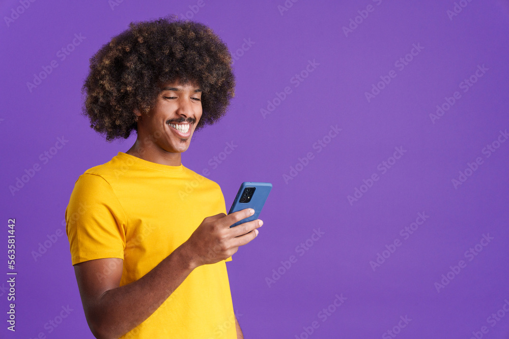 Happy african man smiling while using a mobile Happy african man smiling while using a mobile