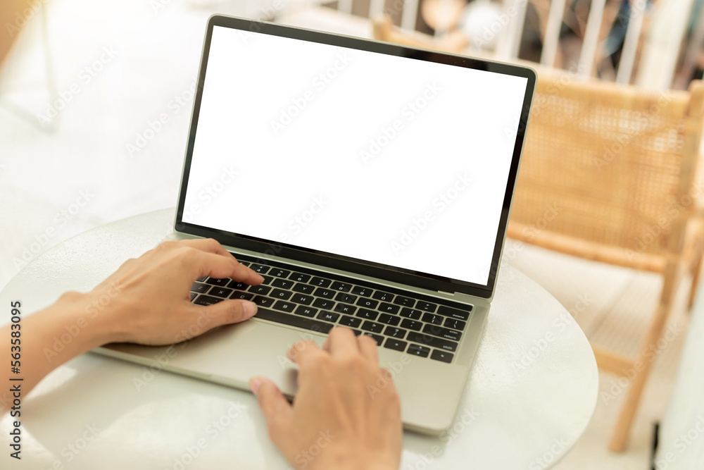 computer screen blank mockup.hand woman work using laptop with white background for advertising,contact business search information on desk at coffee shop.marketing and creative design computer screen blank mockup.hand woman work using laptop with white background for advertising,contact business search information on desk at coffee shop.marketing and creative design