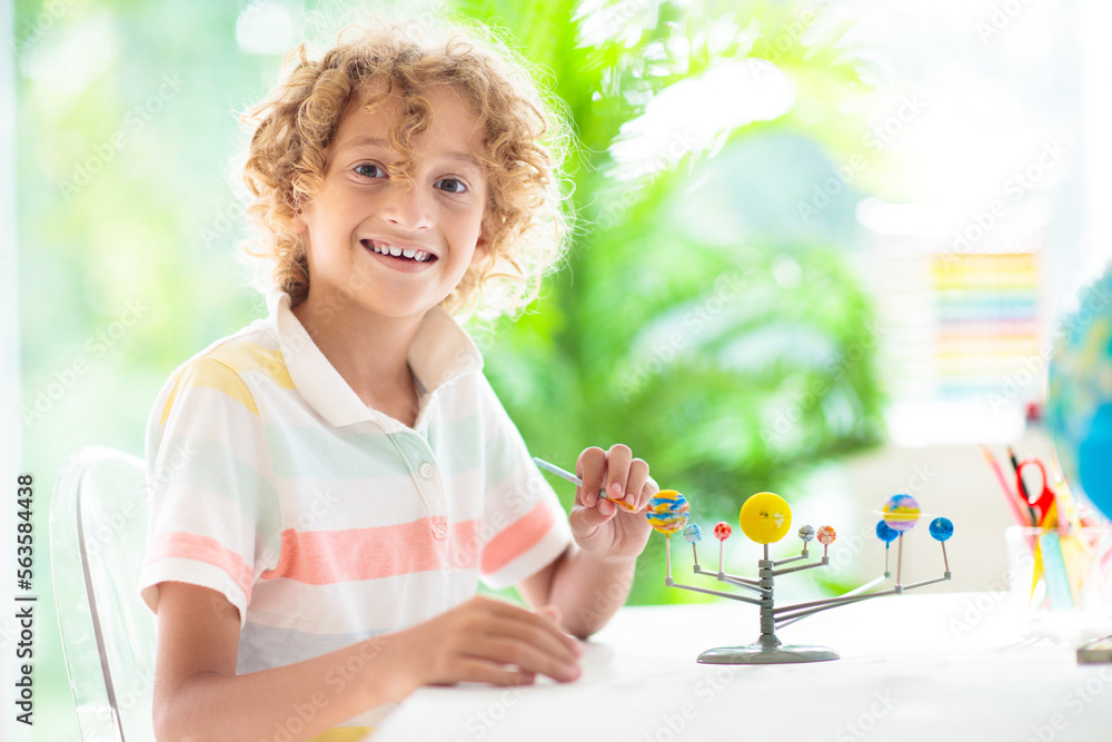 Child with solar system model. Kids planetarium.