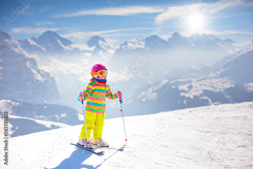 Ski and snow fun. Child in winter mountains.