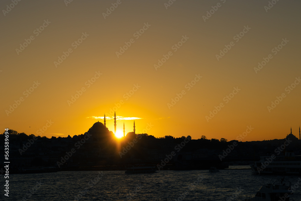 Istanbul skyline at sunset. Suleymaniye Mosque and sunlight beams.