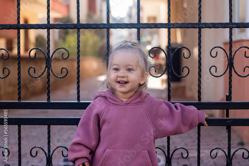 A little girl standing near gates