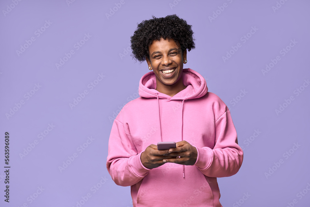 Happy cool curly African American teen guy model wearing pink