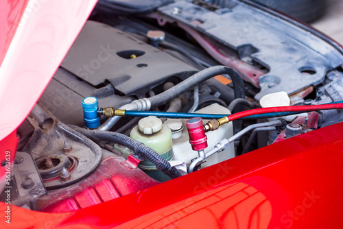 Servicing car air conditioner in vehicle service or repair workshop