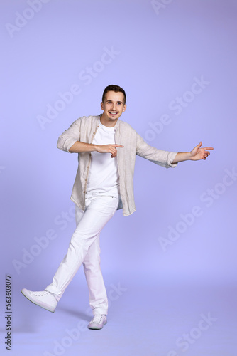 happy man walks isolated on violet background.