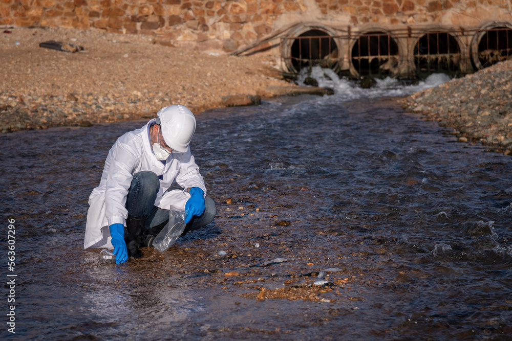 Worker under checking the waste water treatment pond industry large to control water support industry Worker under checking the waste water treatment pond industry large to control water support industry