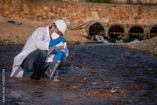 Worker under checking the waste water treatment pond industry large to control water support industry 