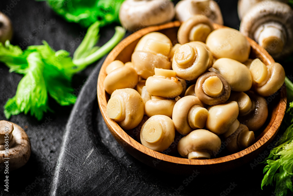 Delicious pickled mushrooms on a cutting board. Delicious pickled mushrooms on a cutting board.
