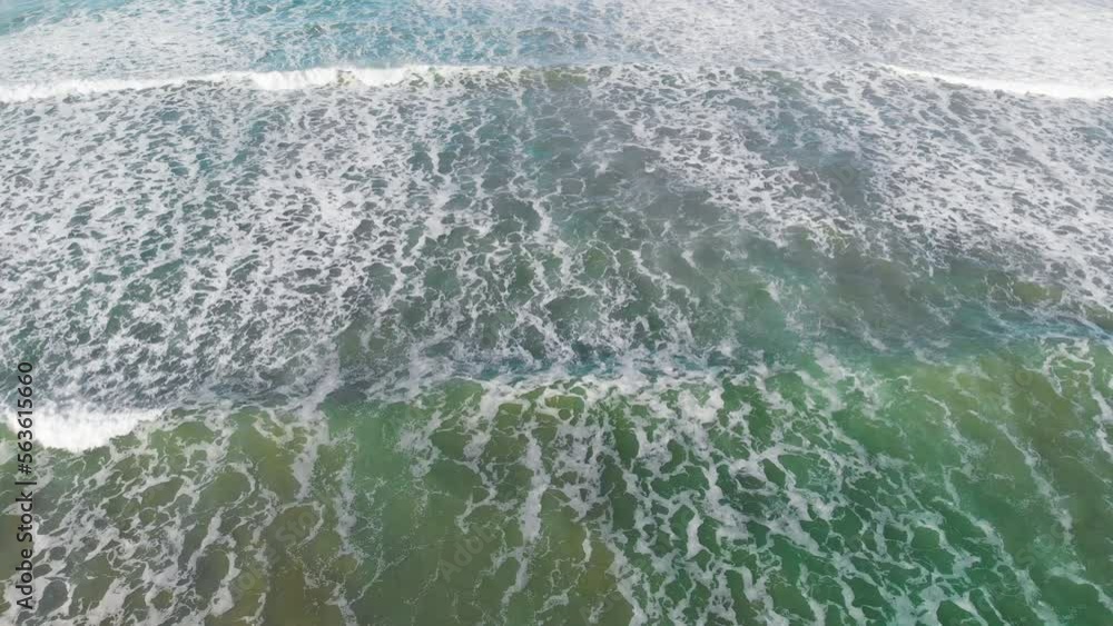 Beautiful waves along the shoreline, overhead aerial view from drone Beautiful waves along the shoreline, overhead aerial view from drone