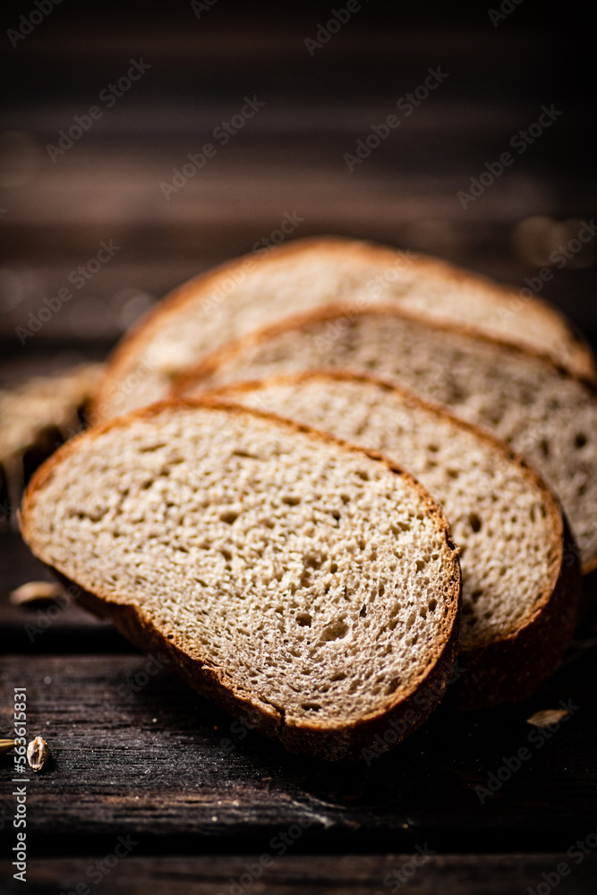 Slices of sliced bread on a table with a spike. Slices of sliced bread on a table with a spike.