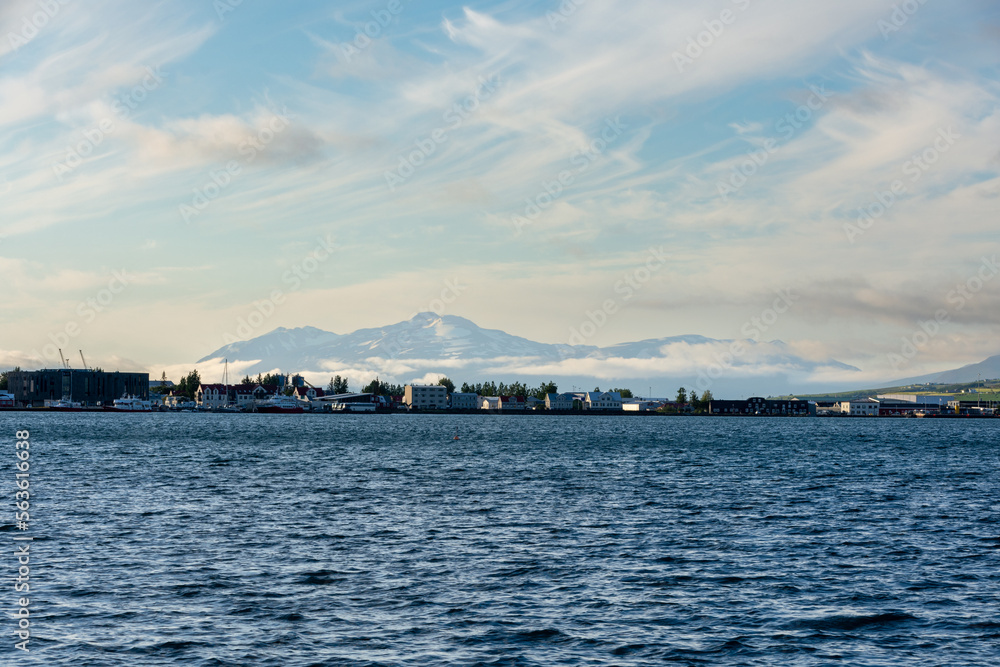 Akureyri in Iceland with Eyjafjördur in the foreground and snow capped mountains in the background