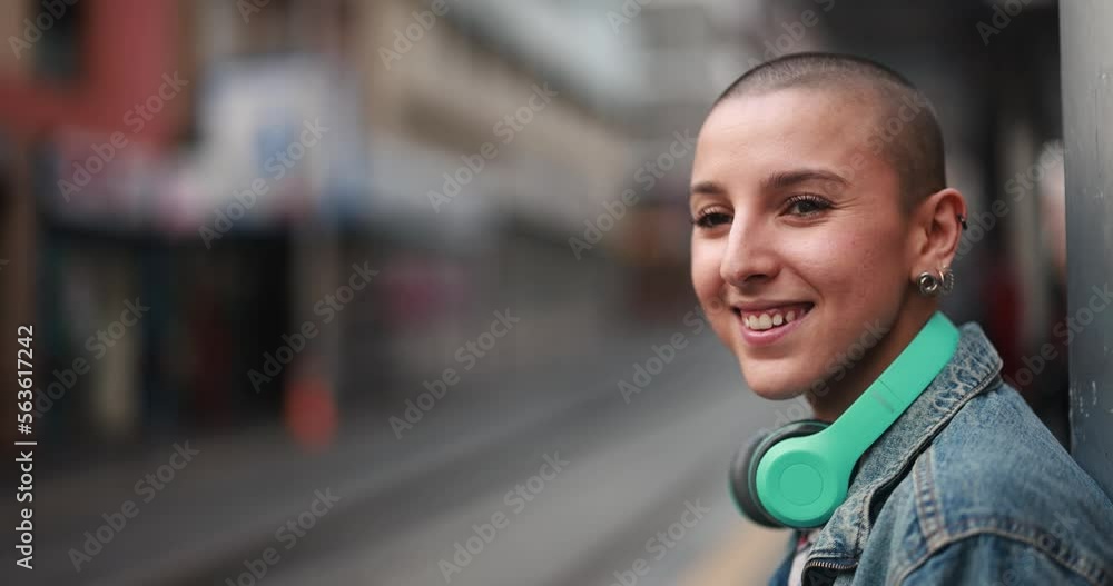 Young bald woman waiting on the tram station Young bald woman waiting on the tram station