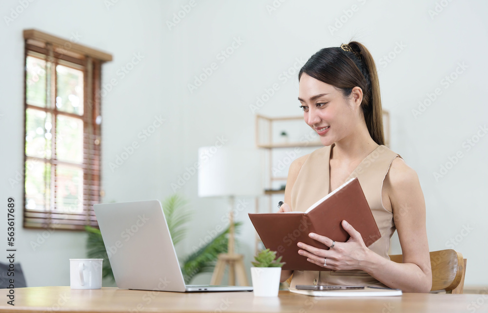 Asian businesswoman meeting at the office, taking notes and using a tablet at the office. Asian businesswoman meeting at the office, taking notes and using a tablet at the office.
