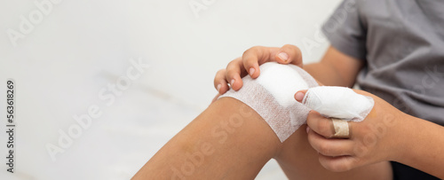 Close up wound on knee and fingers. Asian kid boy was accident injured while playing isolated on white background. Life insurance