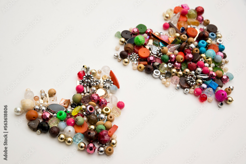 Frame in the shape of hearts. Background of multicolored decorative craft beads. Valentine's Day. Symbol of love.
Frame in the shape of hearts. Background of multicolored decorative craft beads. Valentine's Day. Symbol of love.