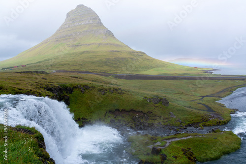Kirkjufell in Iceland with little rainbow in the background