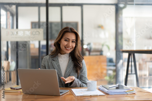 Young woman working with a laptop. Female freelancer connecting to internet via computer. Businesswoman at work.