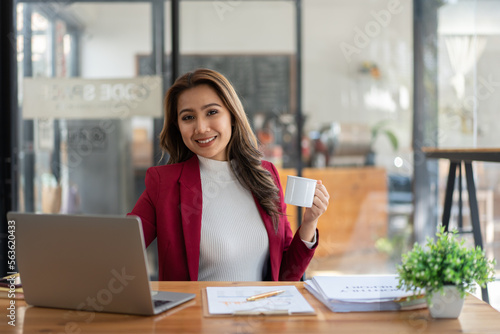 Young woman working with a laptop. Female freelancer connecting to internet via computer. Businesswoman at work.