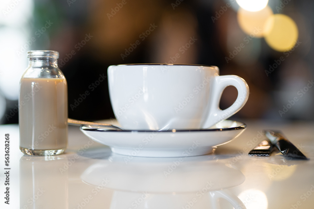 a fragrant and warm mug of cappuccino with a drawing heart, on table. a fragrant and warm mug of cappuccino with a drawing heart, on table.