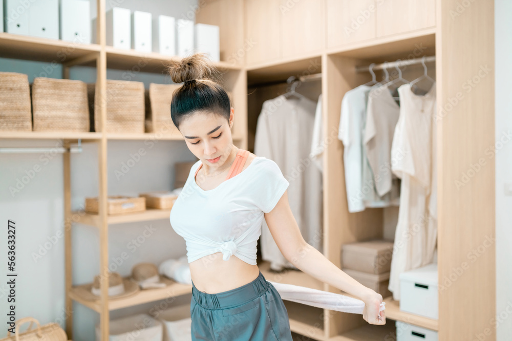 beautiful woman stretching body using cloth in dressing room. motivated woman stretching exercising holding towel with healthy concept. pretty woman balance body holding cloth relax control breathing beautiful woman stretching body using cloth in dressing room. motivated woman stretching exercising holding towel with healthy concept. pretty woman balance body holding cloth relax control breathing