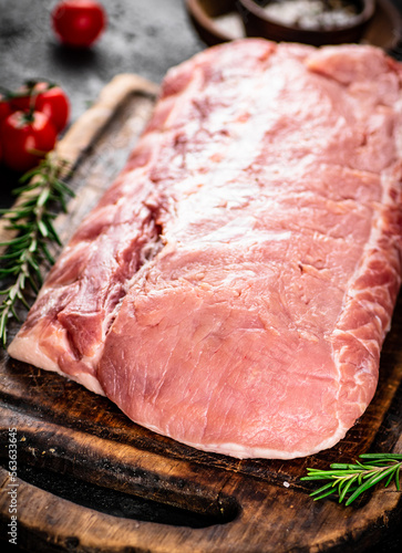 Raw pork with rosemary and tomatoes. 