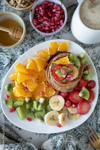 Pancakes with fresh fruit. Fruit salad with gluten-free pancakes. Healthy breakfast full of vitamins