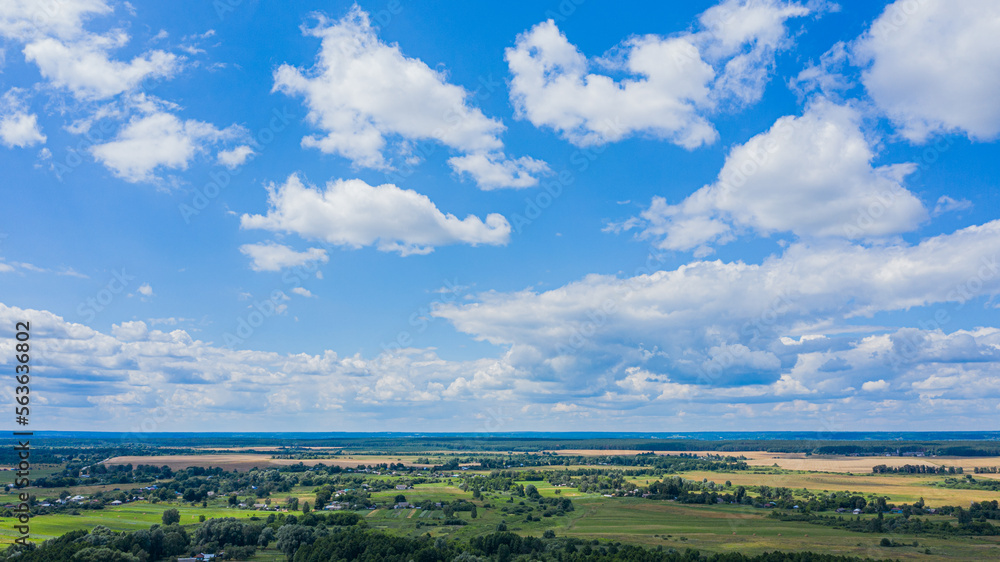 Aerial view over beautiful suburb in wide valley, in the summer. Top view to the small village with a beautiful green landscape. Aerial view over beautiful suburb in wide valley, in the summer. Top view to the small village with a beautiful green landscape.