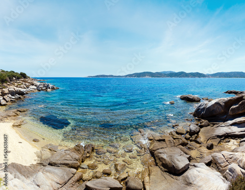Summer sea scenery with aquamarine transparent water and sandy beach. View from shore (Sithonia, Halkidiki, Greece).