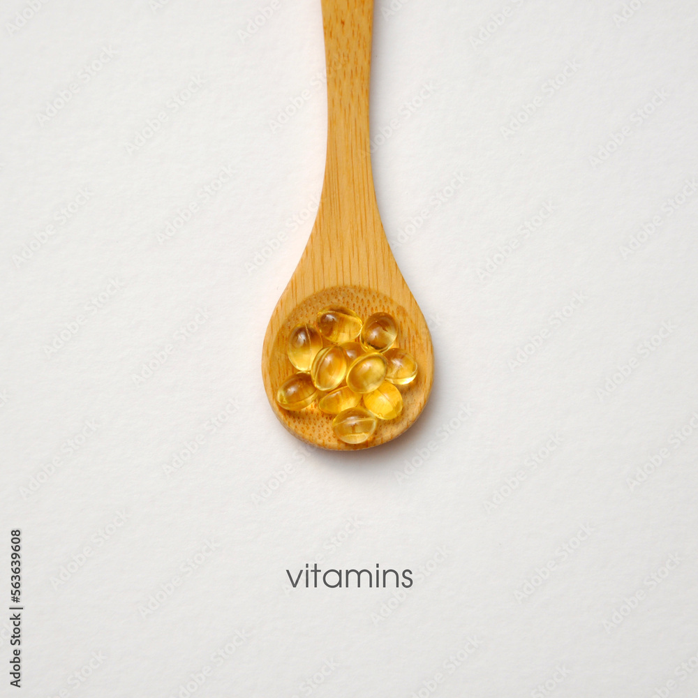 Capsules with vitamins on a spoon. A complex of vitamins for health Capsules with vitamins on a spoon. A complex of vitamins for health