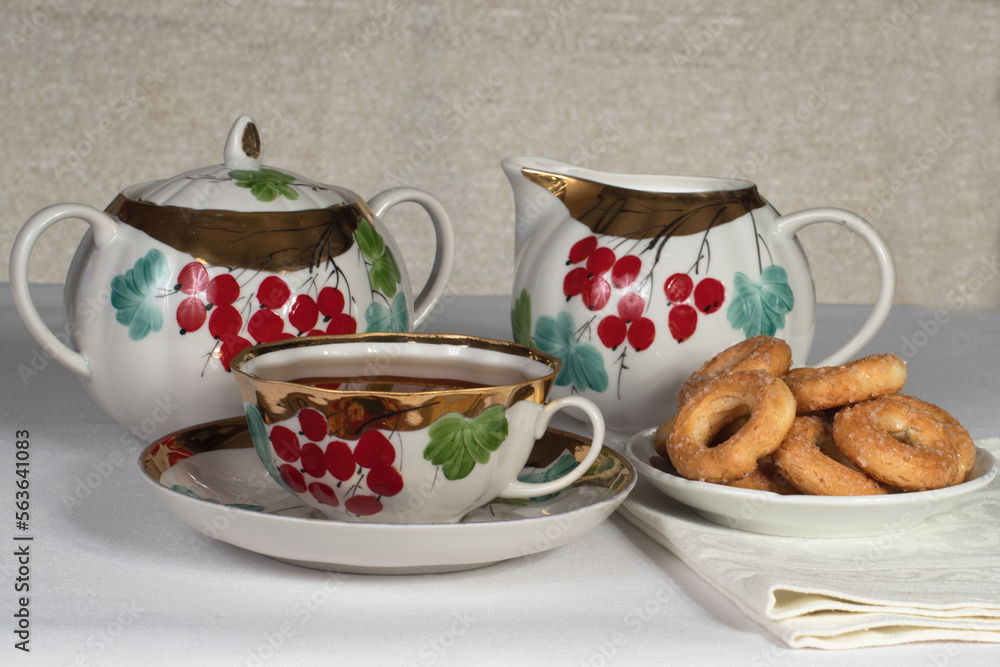 Fototapeta premium tea set with cookies on a white tablecloth